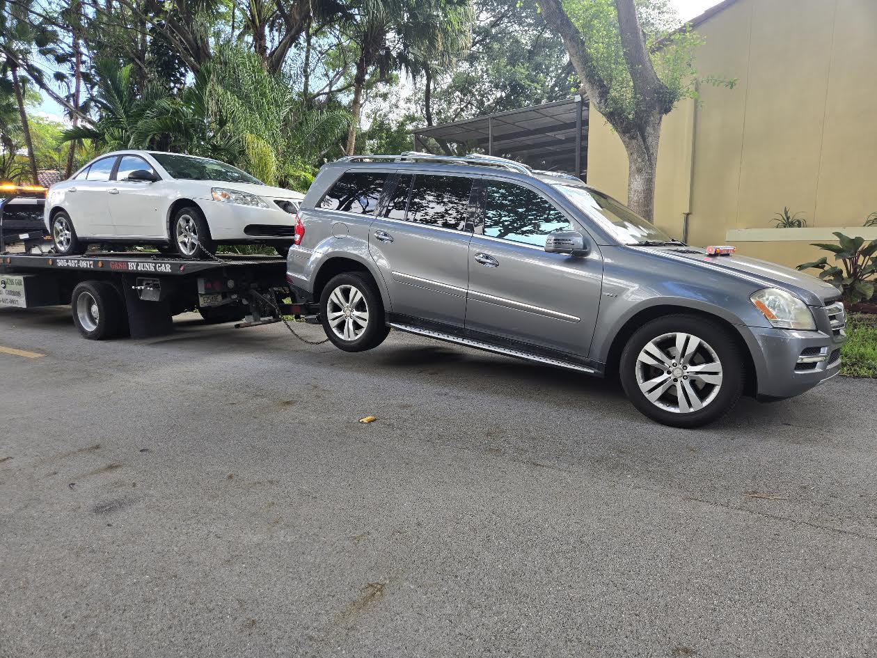 Real flatbed vehicle pickup with cars prepared for transport