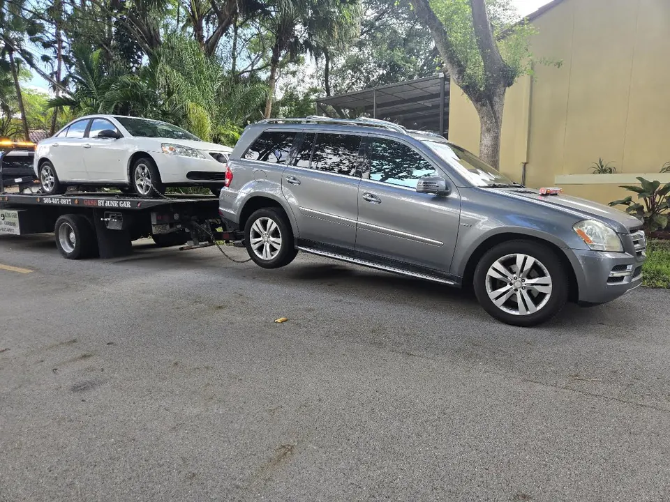 Real flatbed vehicle pickup with cars prepared for transport